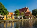 A beautiful golden roof Buddhist Temple near a canal.